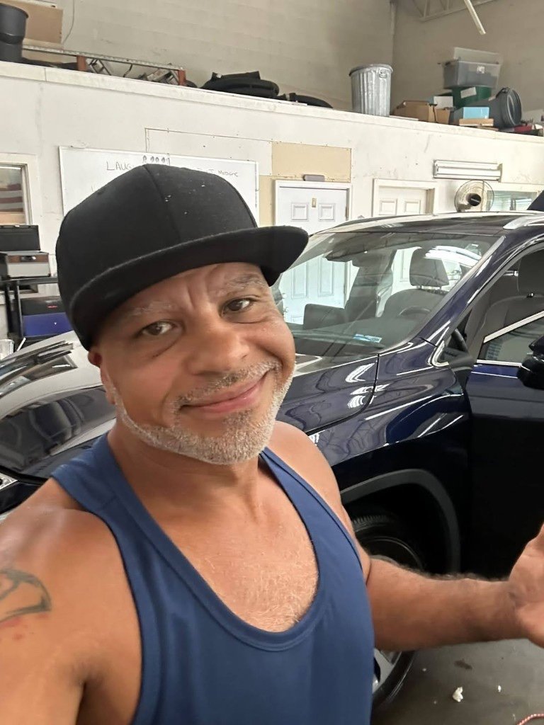 Tony, owner of Tony’s First Choice Detail, in the shop with a detailed SUV