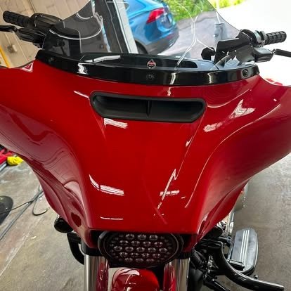 Gloss finish on a red motorcycle fairing after detailing by Tony