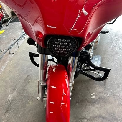 Front fairing of a red touring motorcycle detailed by Tony